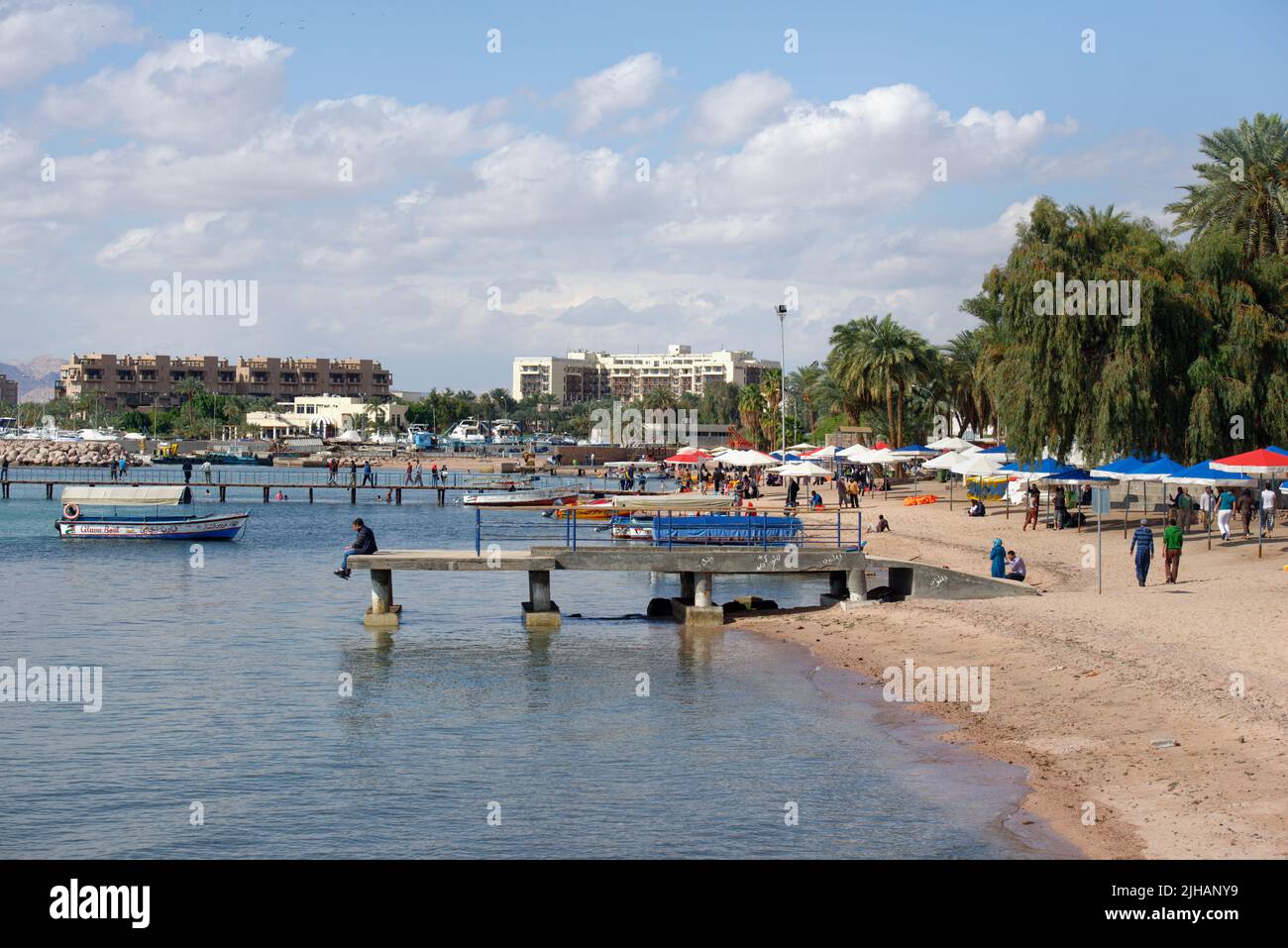 Aqaba, Jordan - March 14, 2014: Boats on the beach of Aqaba in springtime. Glass bottom boats allow tourists to see corals and fishes Stock Photo