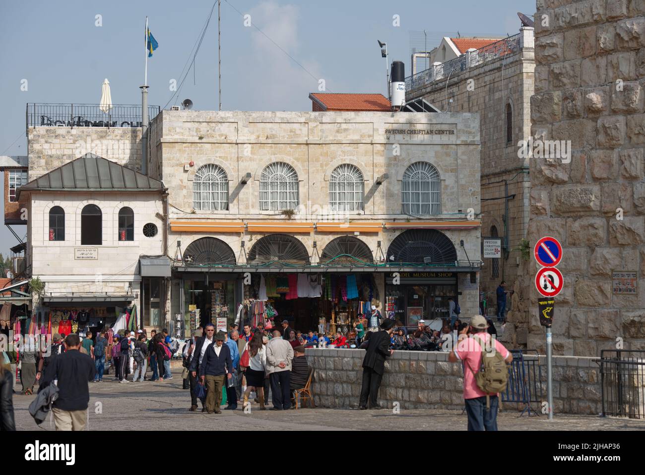 People on Omar Ibn Al-Khattab square in the Old City of Jerusalem, Israel, at the building of Swedish Christian Study Centre Stock Photo