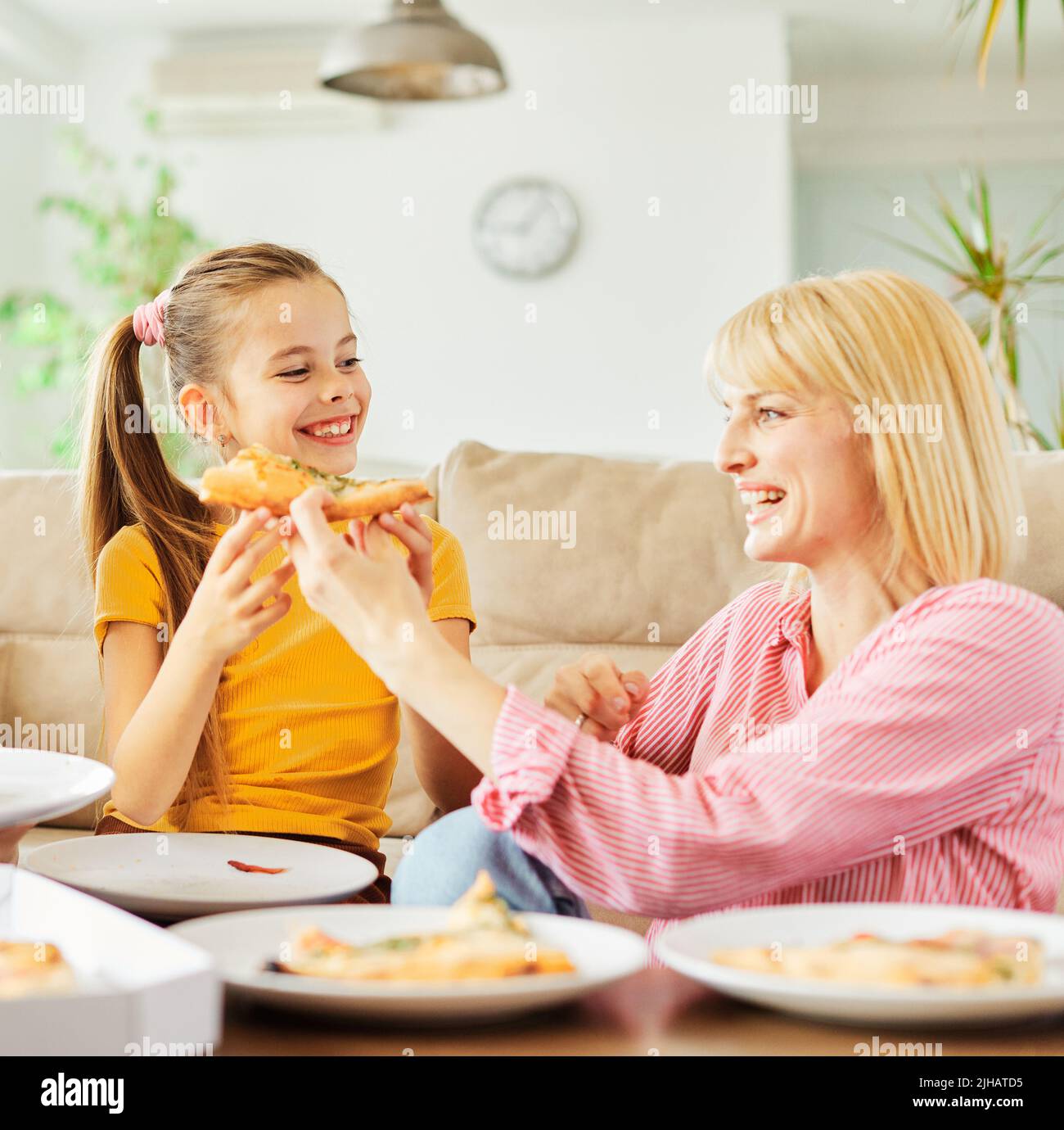 pizza family child food home eating daughter mother happy meal together lunch dinner woman girl fun Stock Photo