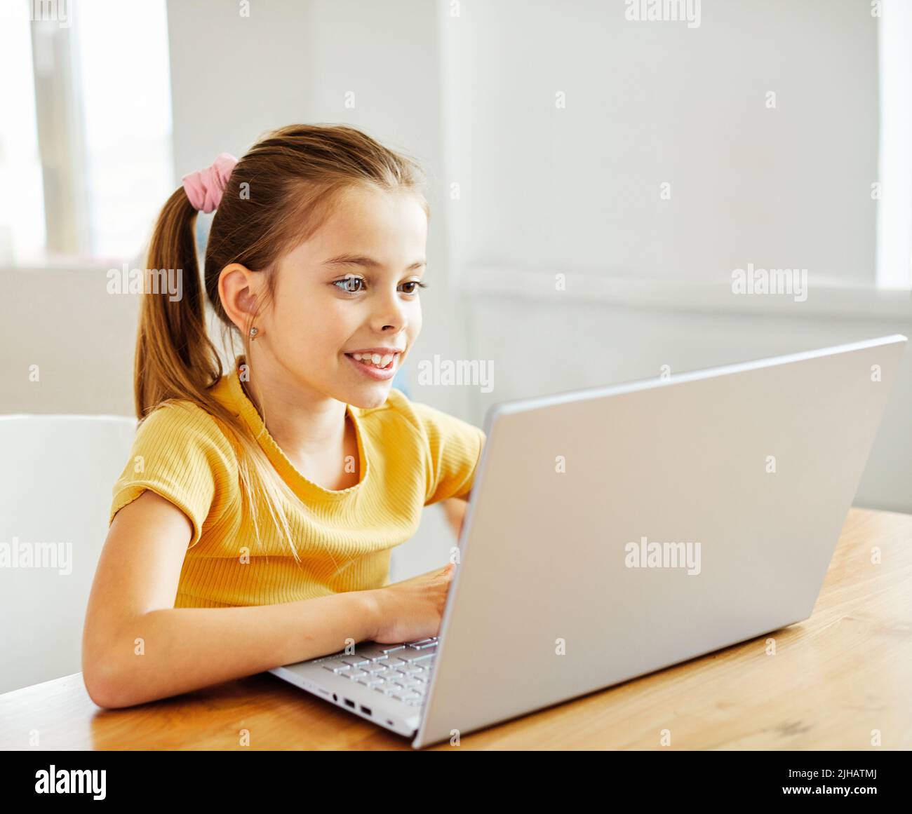 child laptop computer technology home girl education homework kid learning internet childhood student sitting connection using online Stock Photo