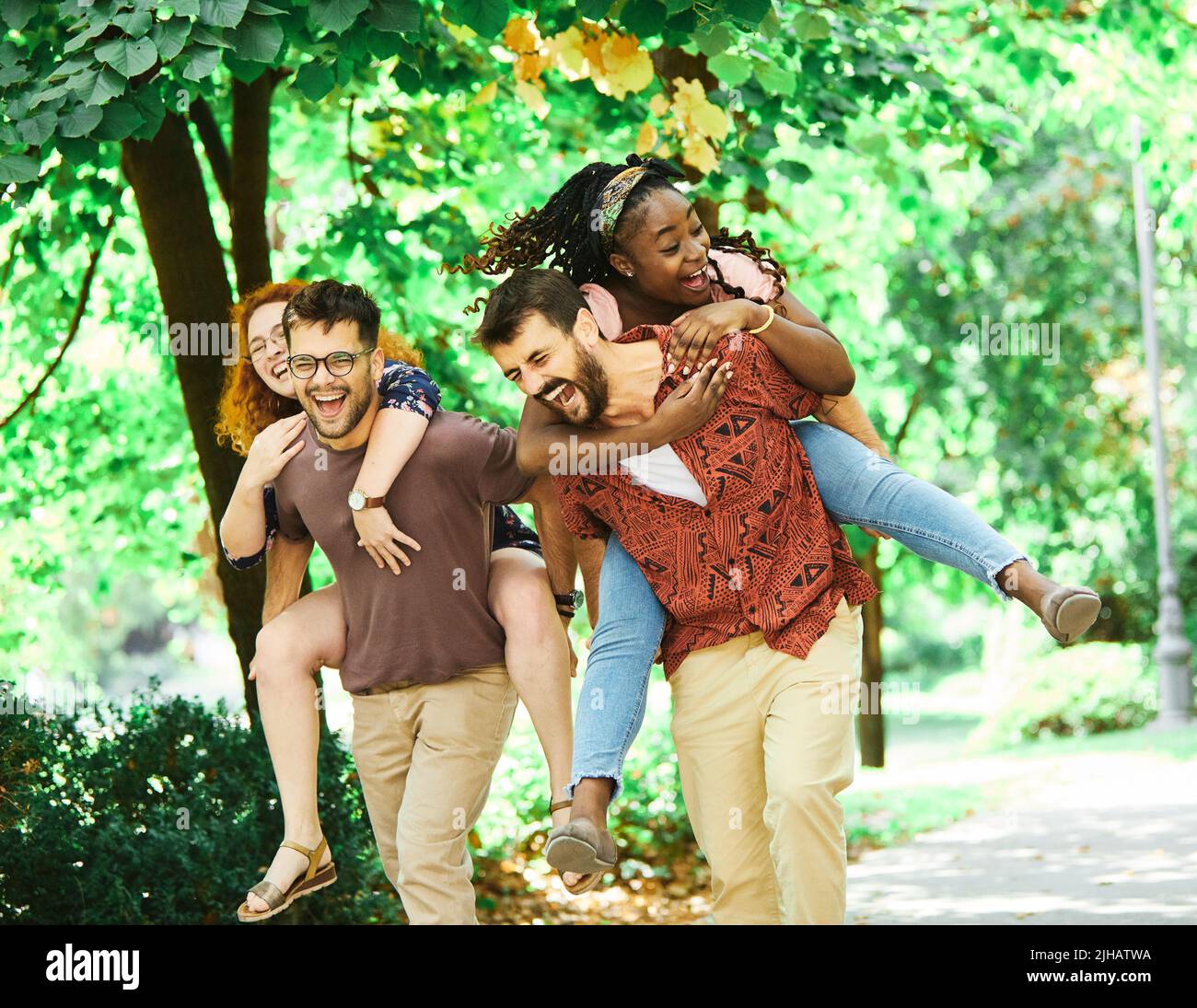young people having fun happy group friendship student lifestyle piggyback youth teamwork together Stock Photo