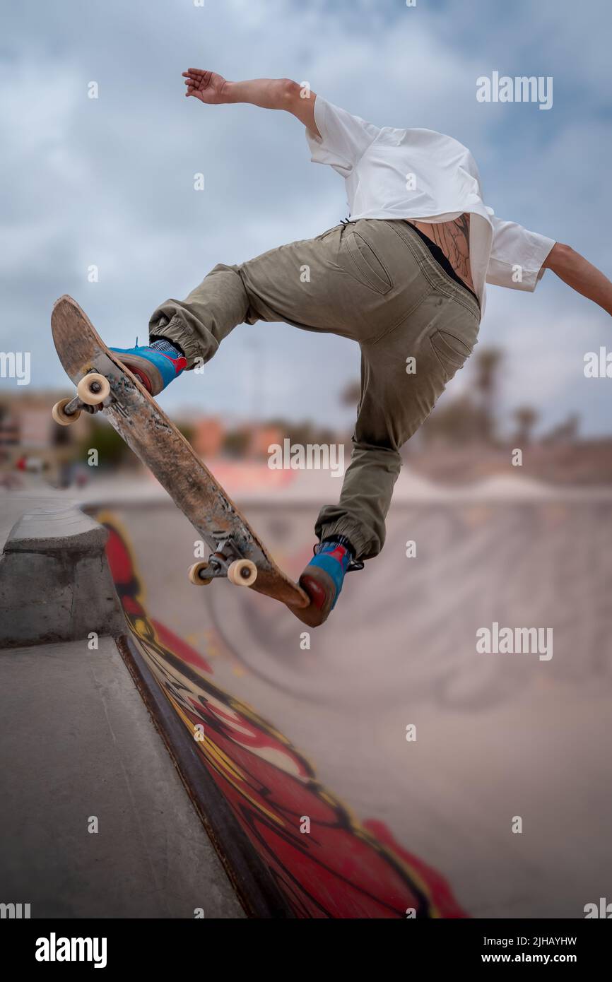 young skateboarder makes a trick called "Fakie noseblunt" in a skate