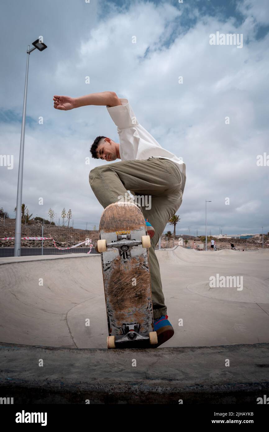 young skateboarder makes a trick called "Fakie noseblunt" in a skate