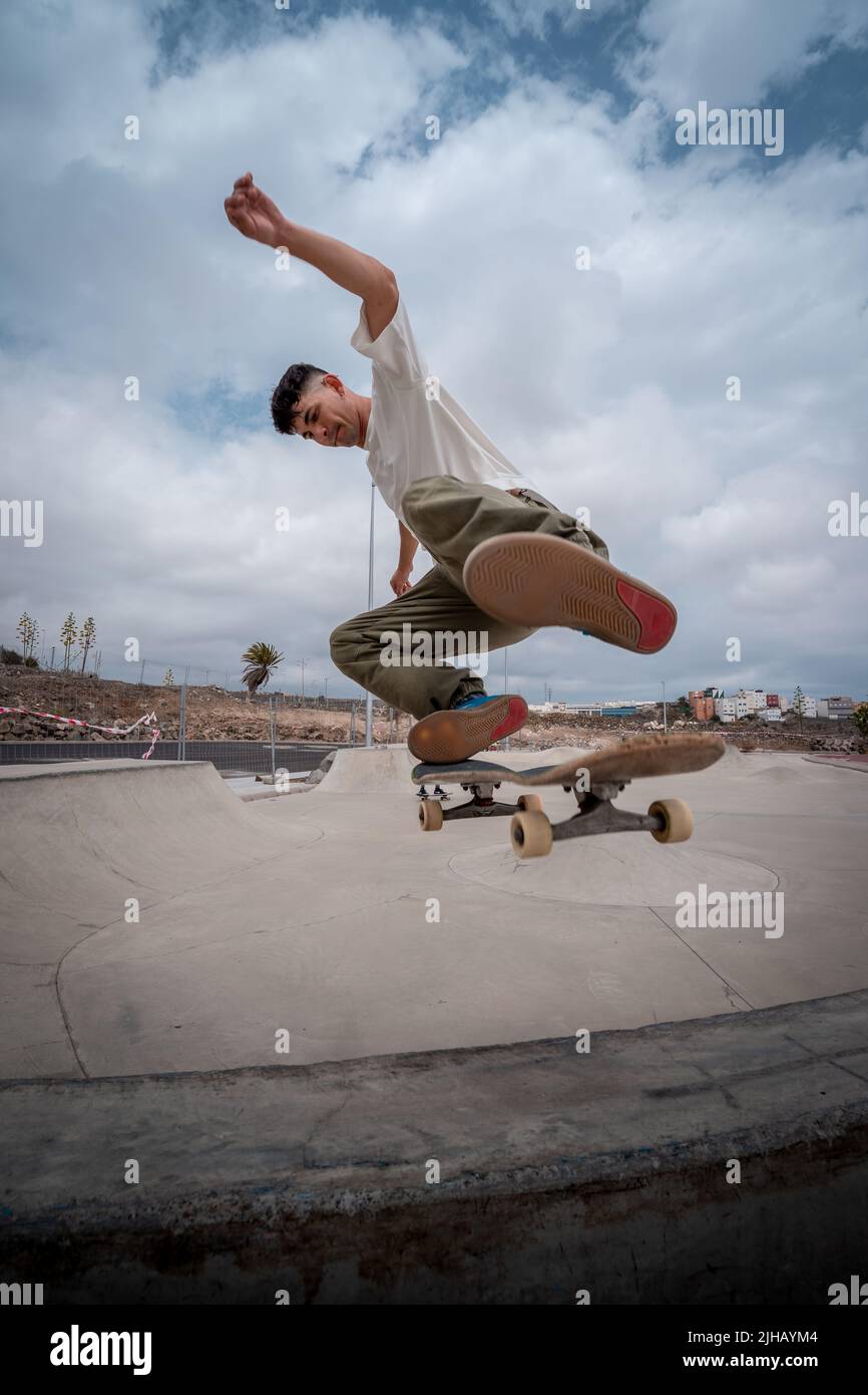 young skateboarder makes a trick called "Fakie noseblunt" in a skate