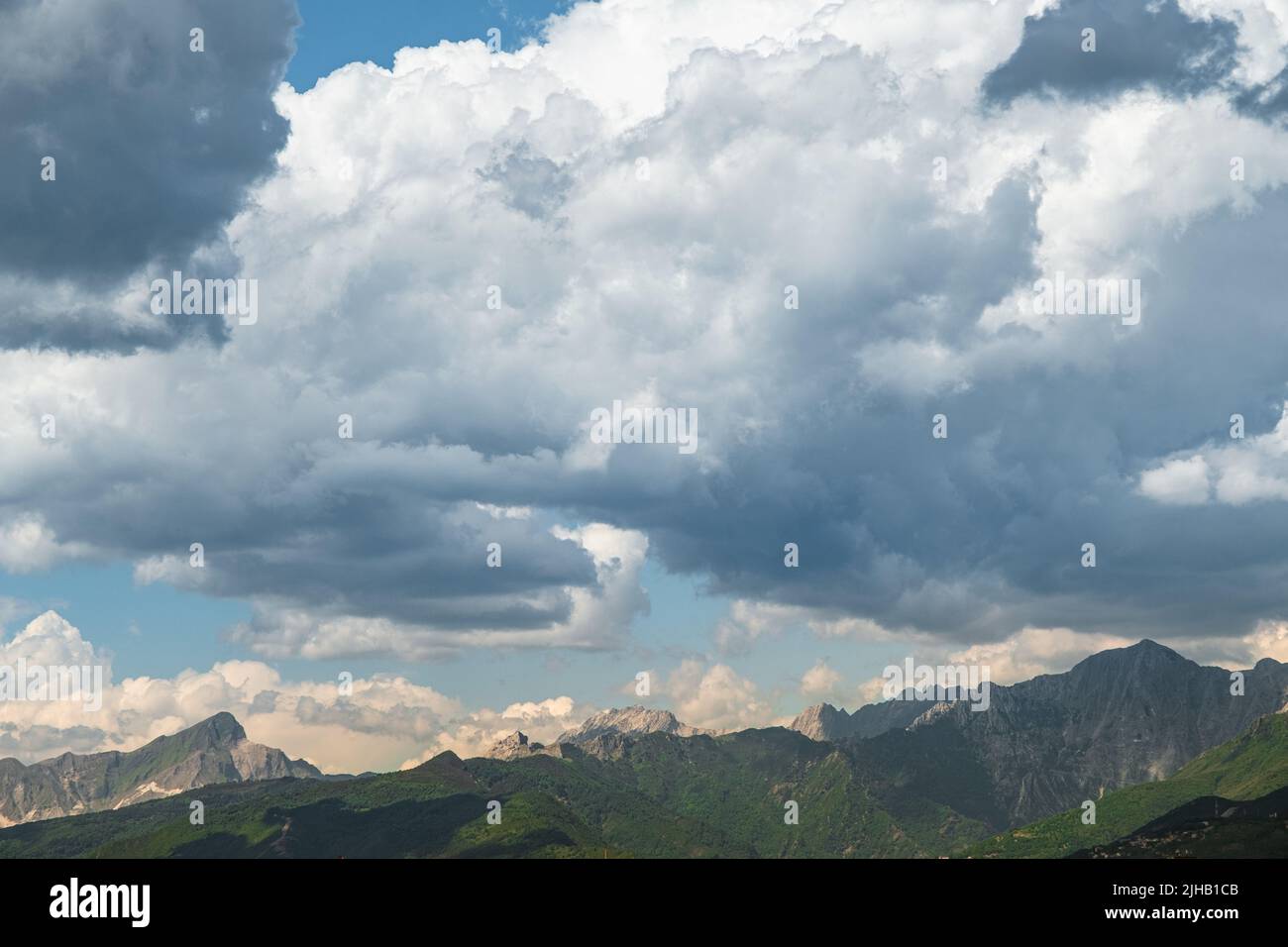 Stunning Italian Appenine mountains as seen from Viareggio with dramatic cloudscape. Stock Photo