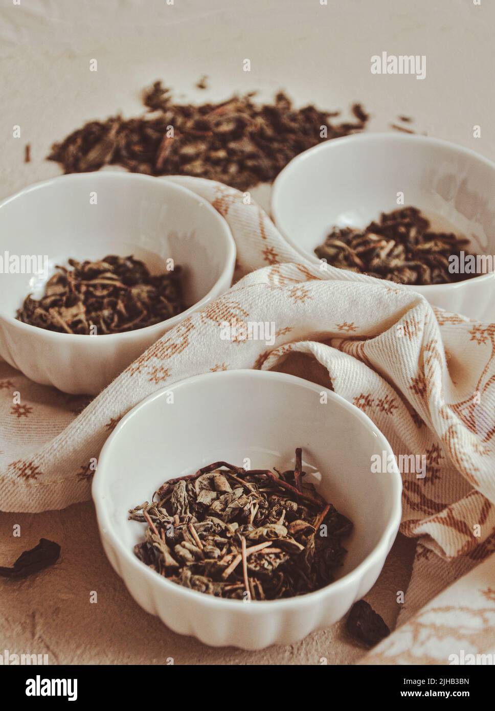 Small bowls with dried healing green tea and herbs, ritual purification and cleansing, closeup Stock Photo