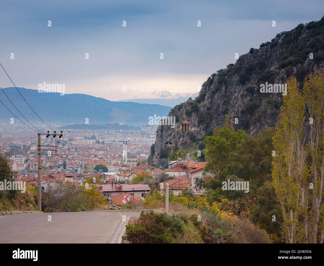 Aerial view of Fethiye landscape and cityscape. View from top. Fethiye, Mediterranean sea, Turkey. Lycian tomb in rocks above city of Fethiye overlooking mountains in snow. Stock Photo