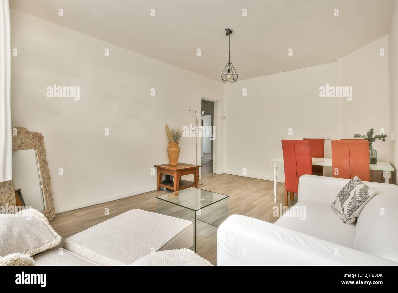 Couches and table located against dining area of spacious room in ...