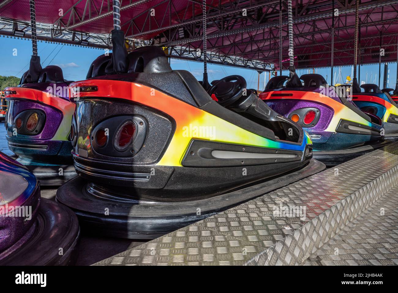 row of electric bumper cars on funfair Stock Photo