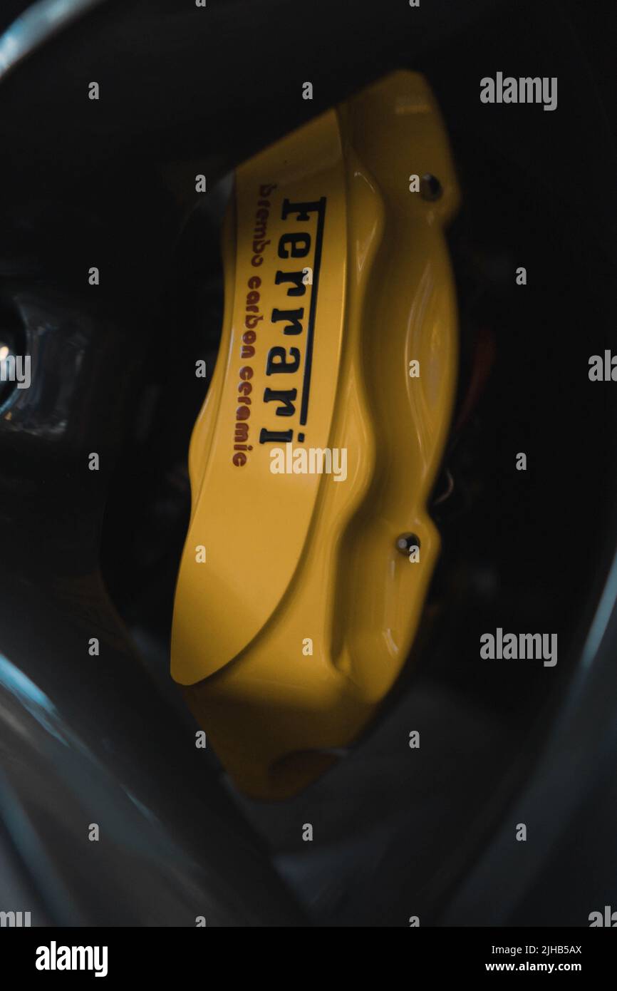 A vertical closeup shot of a brake disc of a Ferrari car Stock Photo