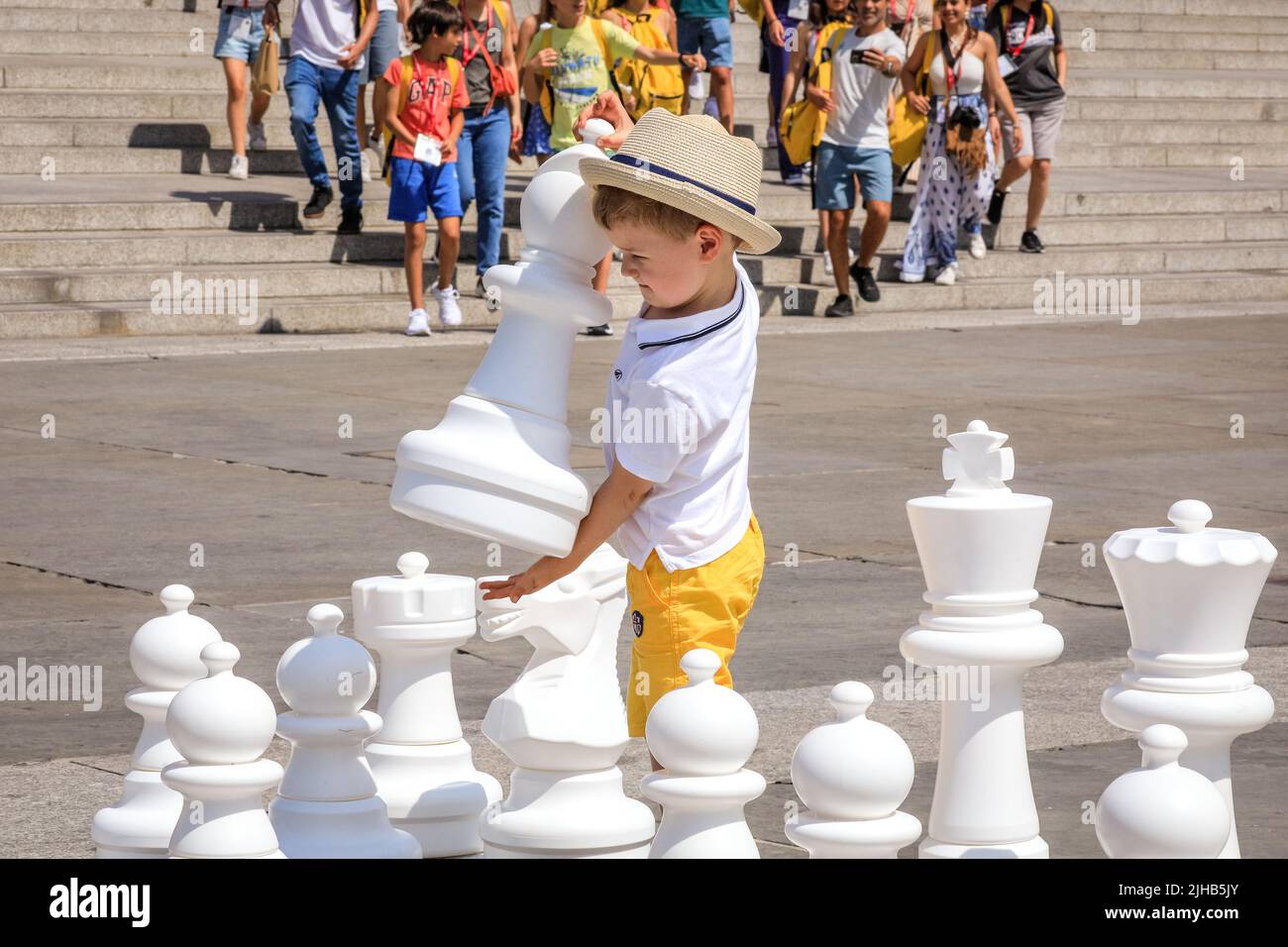 London, UK. 17th July, 2022. Albert (3), has decided on a move as he plays a game of chess with his dad. The UK's largest one-day chess event takes place on London's Trafalgar Square and is aimed at anyone who loves or wants to learn chess, and is free of charge. Credit: Imageplotter/Alamy Live News Stock Photo