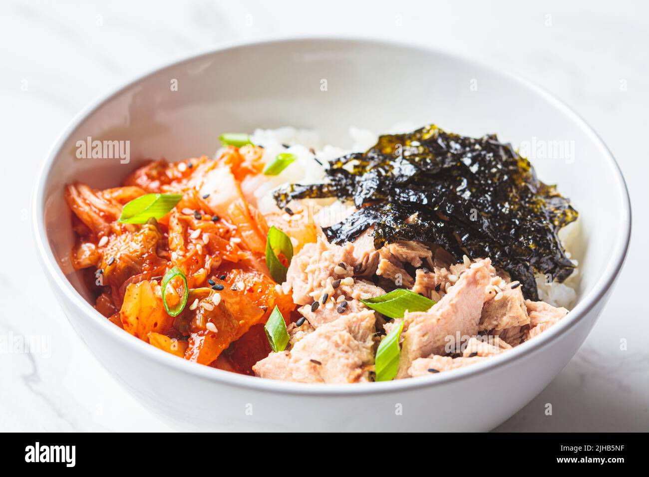 Kimchi tuna rice salad in a white bowl. Traditional Korean food Stock Photo Alamy