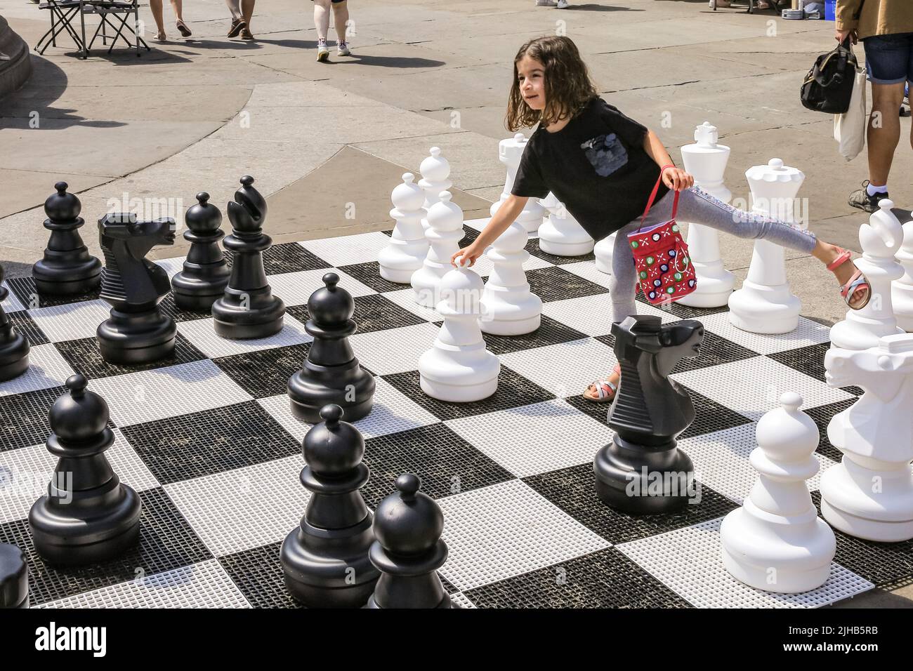 London, UK. 17th July, 2022. A young player named Gabriella celebrates her birthday with a game of chess with her family. The UK's largest one-day chess event takes place on London's Trafalgar Square and is aimed at anyone who loves or wants to learn chess, and is free of charge. Credit: Imageplotter/Alamy Live News Stock Photo