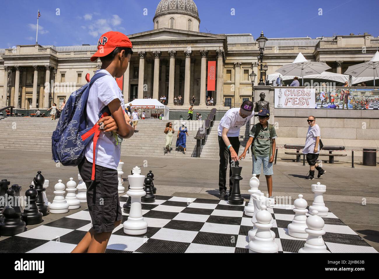 London, UK. 17th July, 2022. Players of all ages and capabilities play chess on the square. The UK's largest one-day chess event takes place on London's Trafalgar Square and is aimed at anyone who loves or wants to learn chess, and is free of charge. Credit: Imageplotter/Alamy Live News Stock Photo