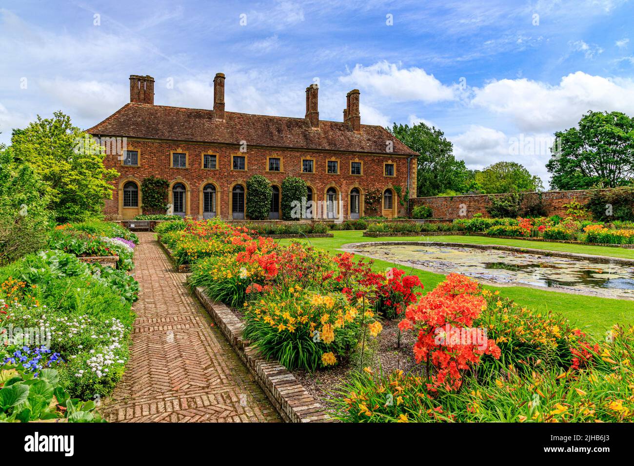 Colourful spring flowering azaleas and bedding plants in the Lily Garden of Strode House on the Barrington Court estate, Somerset, England, UK Stock Photo