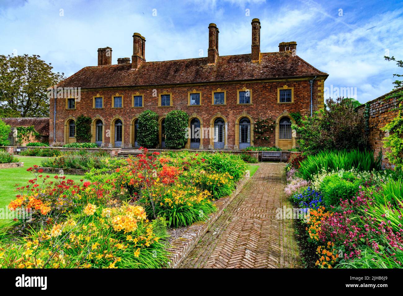 Colourful spring flowering azaleas and bedding plants in the Lily Garden of Strode House on the Barrington Court estate, Somerset, England, UK Stock Photo