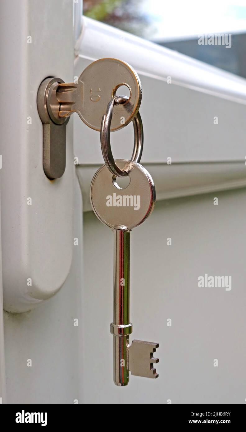 Key in a door, property rental or sale, private on a mortgage or social housing, on a keyring Stock Photo