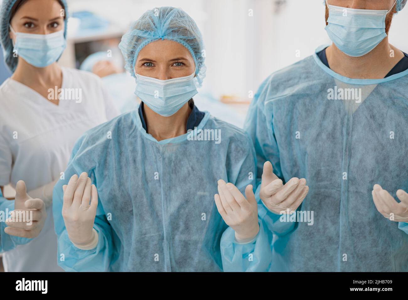 Team of surgeons in the operating room ready for surgery and waiting on patient and looking camera Stock Photo