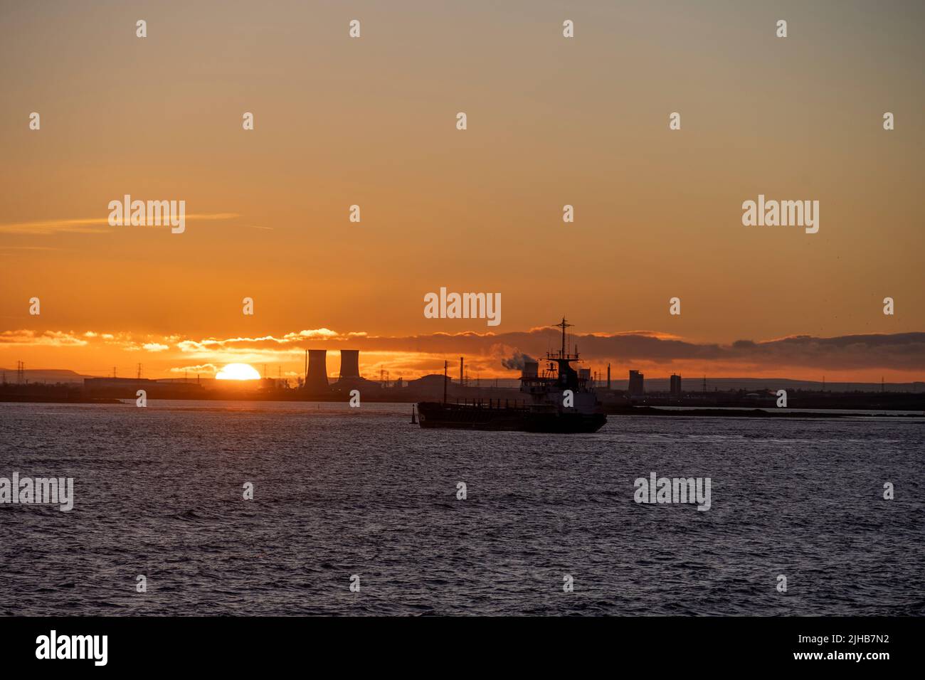 Ship Entering the Tees at Sunset, Teesmouth, Cleveland Stock Photo