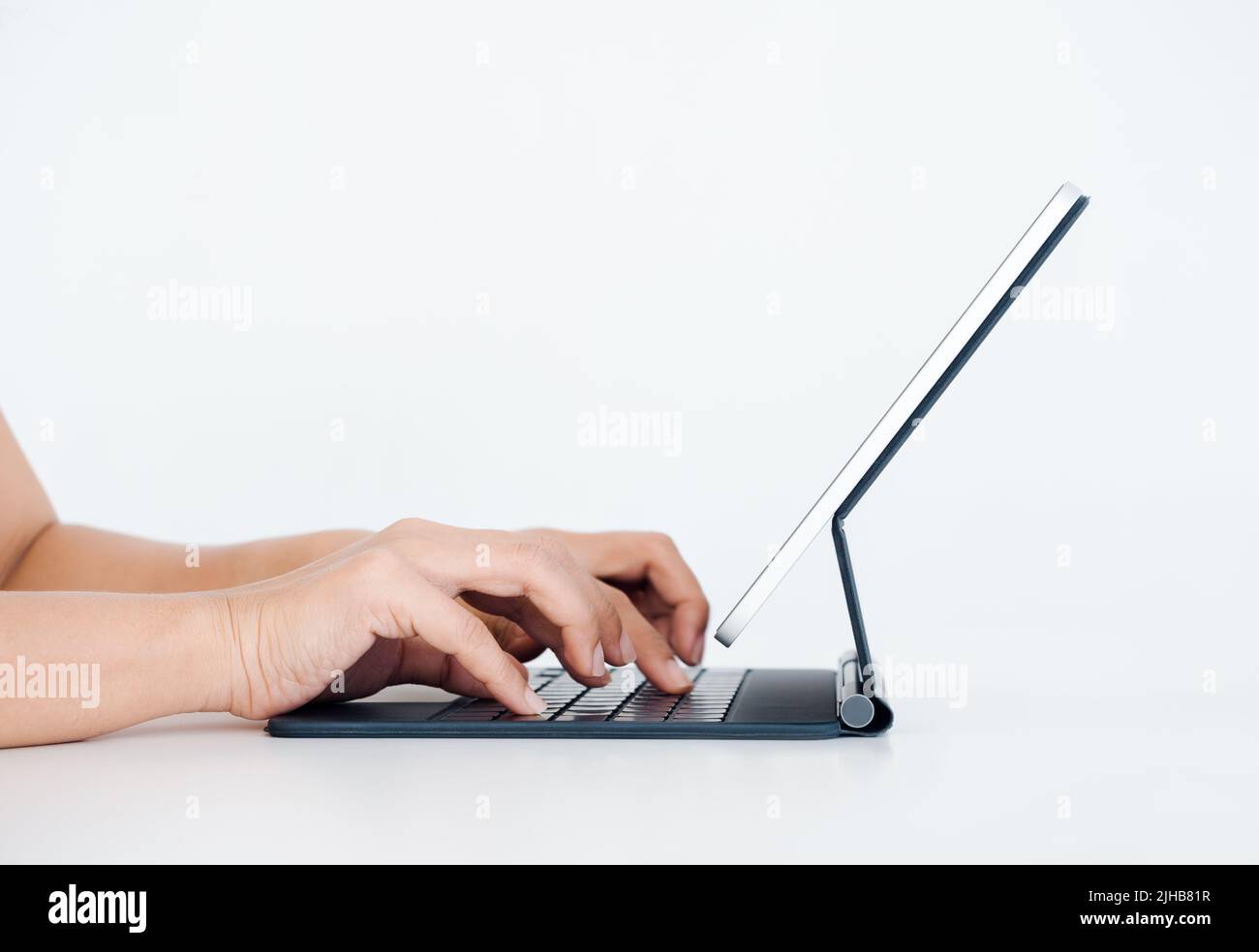 Hands typing on keyboard computer on digital tablet screen on standing ...