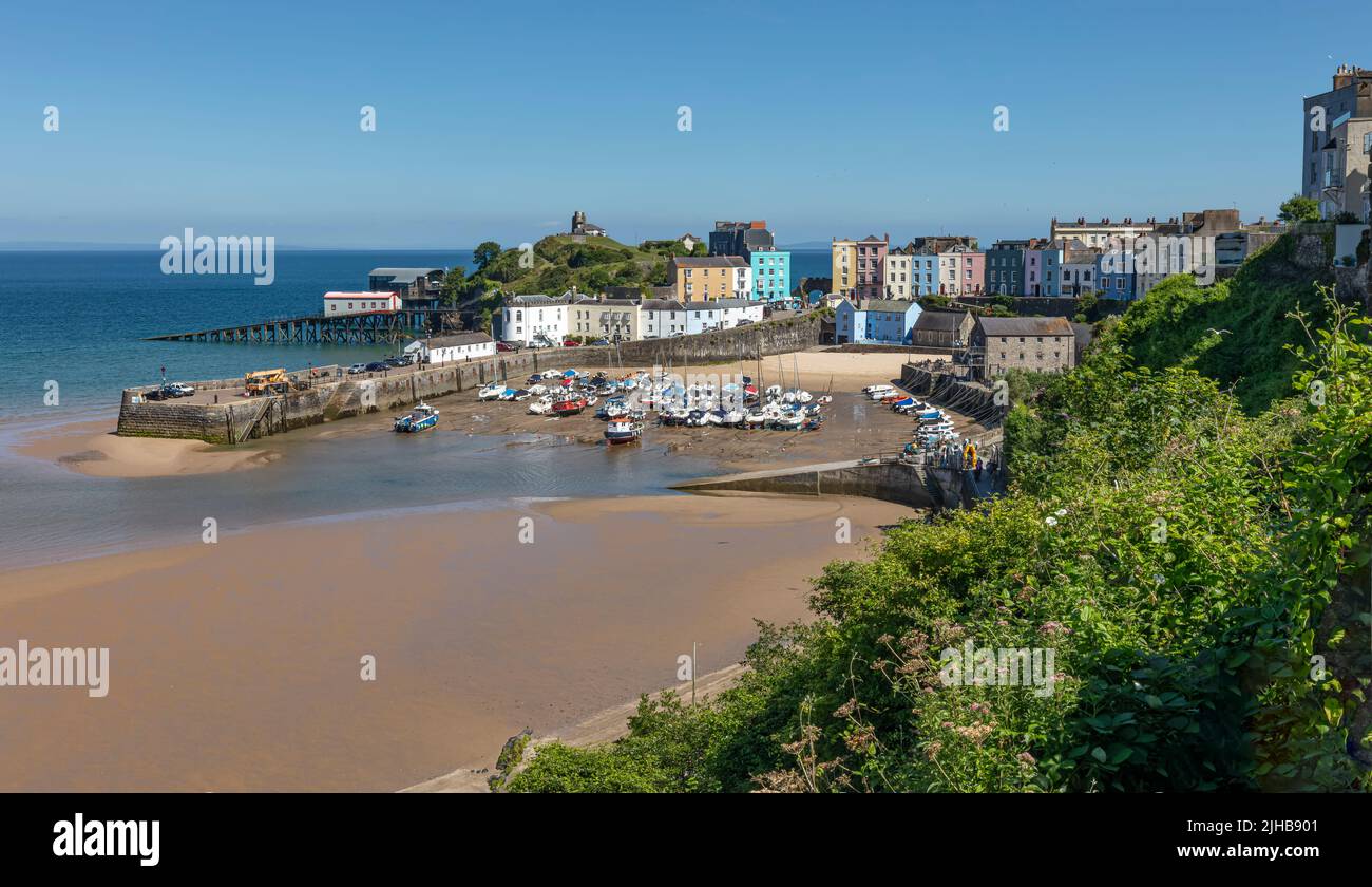 View of Tenby Harbour on a sunny day at low tide Stock Photo