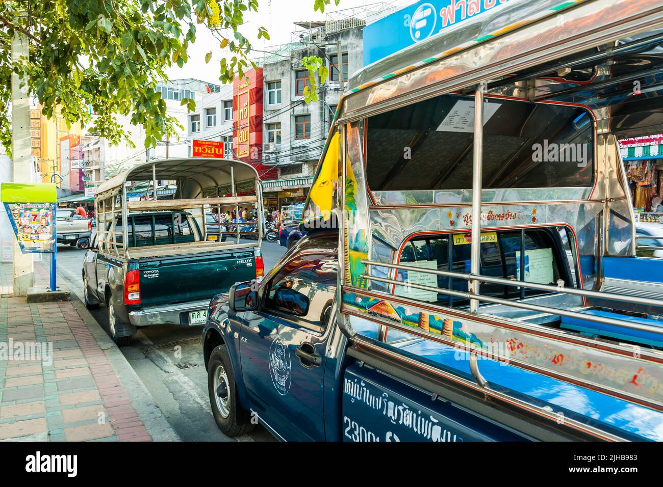 Pattaya, Thailand - December 4, 2009: Street with parked city songthaews in Pattaya Stock Photo