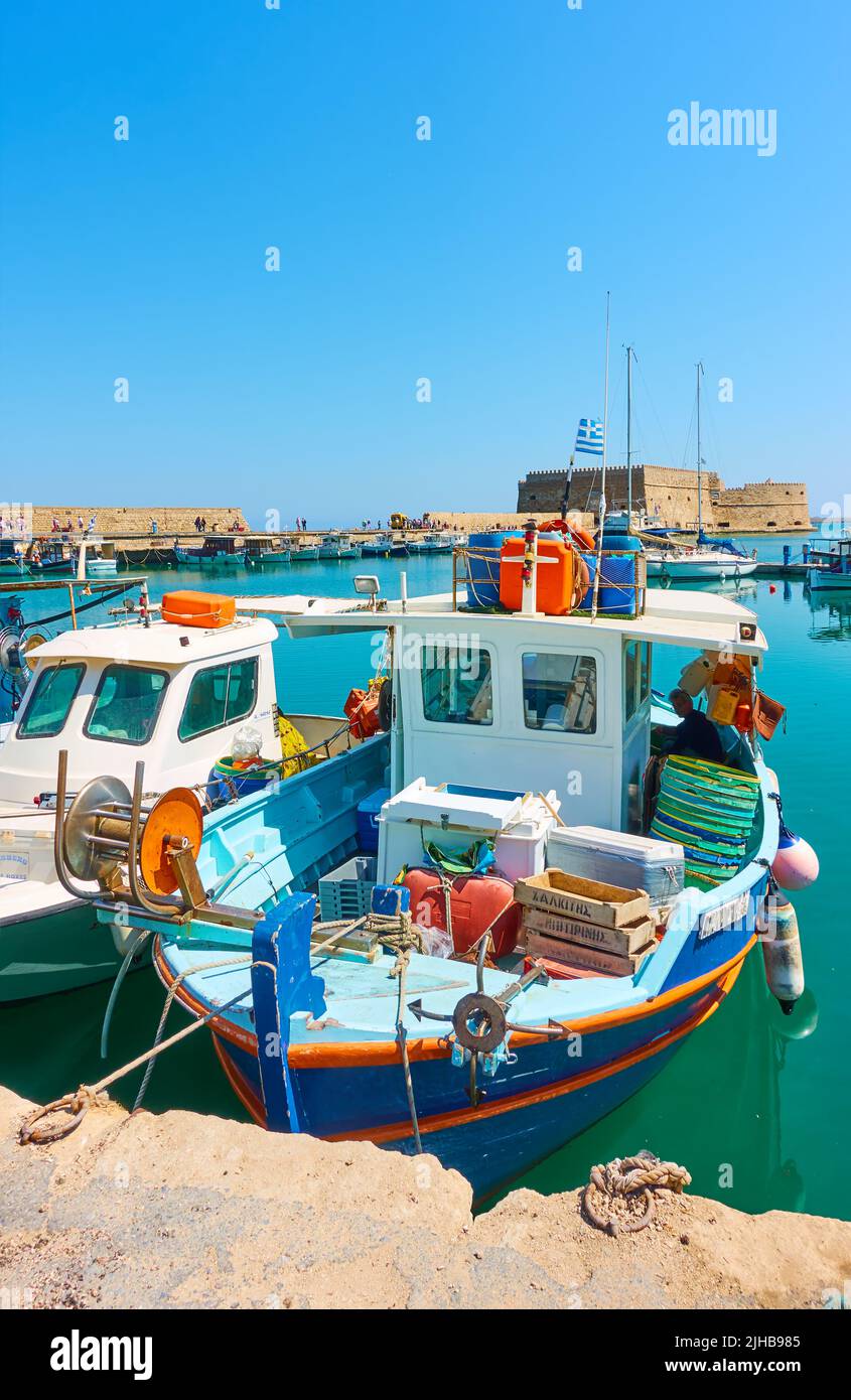 Heraklion, Greece - April 27, 2018: Fishing boats in the harbour by the Venetian Fortress in Heraklion, Crete island Stock Photo