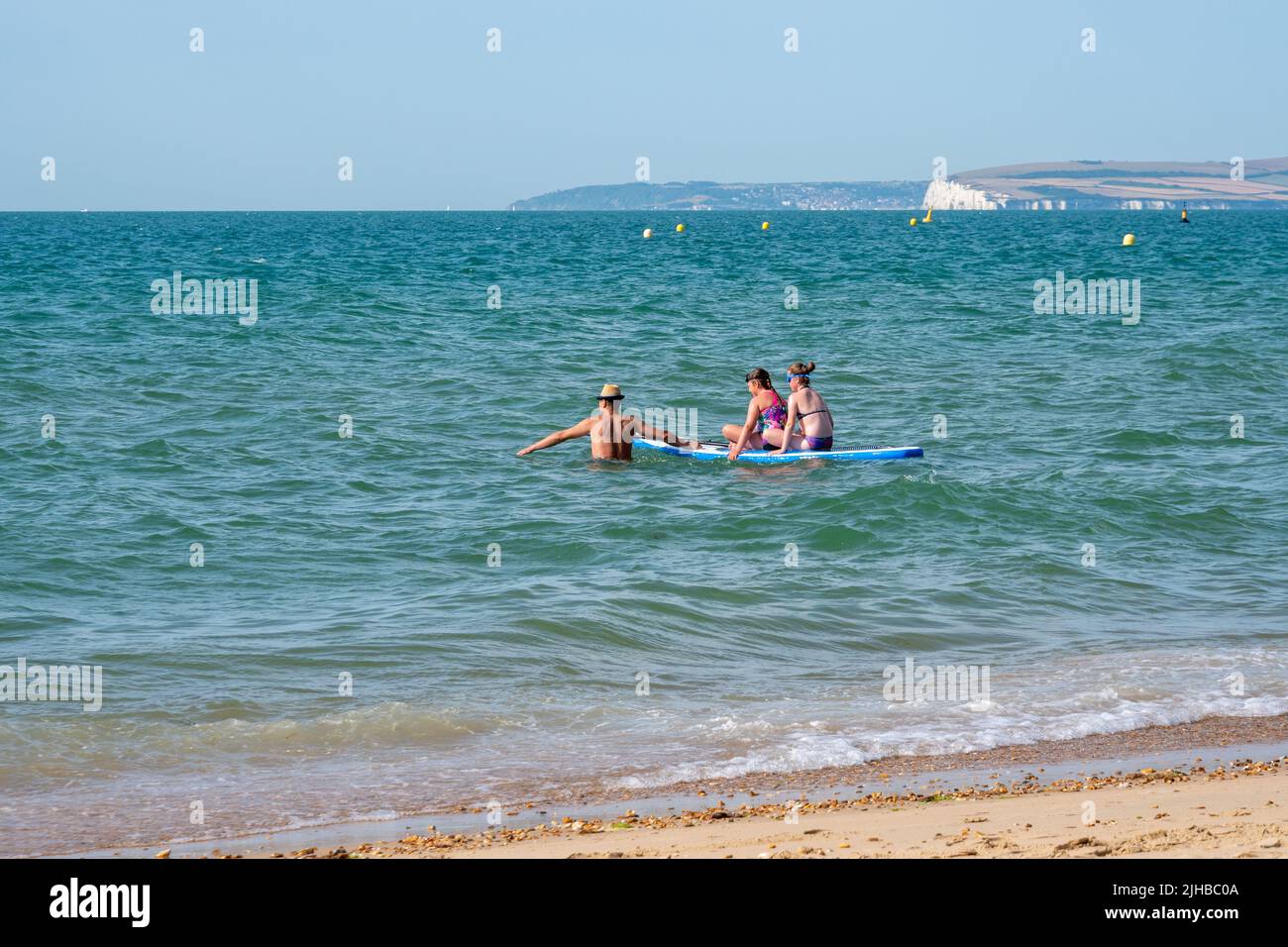 Boscombe Beach, Bournemouth, Dorset, England, UK, 17th July 2022, Weather. Record breaking heatwave moves in across the south coast and an amber warning is in place from the Met Office for heat. Paddleboarders having fun in the sunshine. Credit: Paul Biggins/Alamy Live News Stock Photo