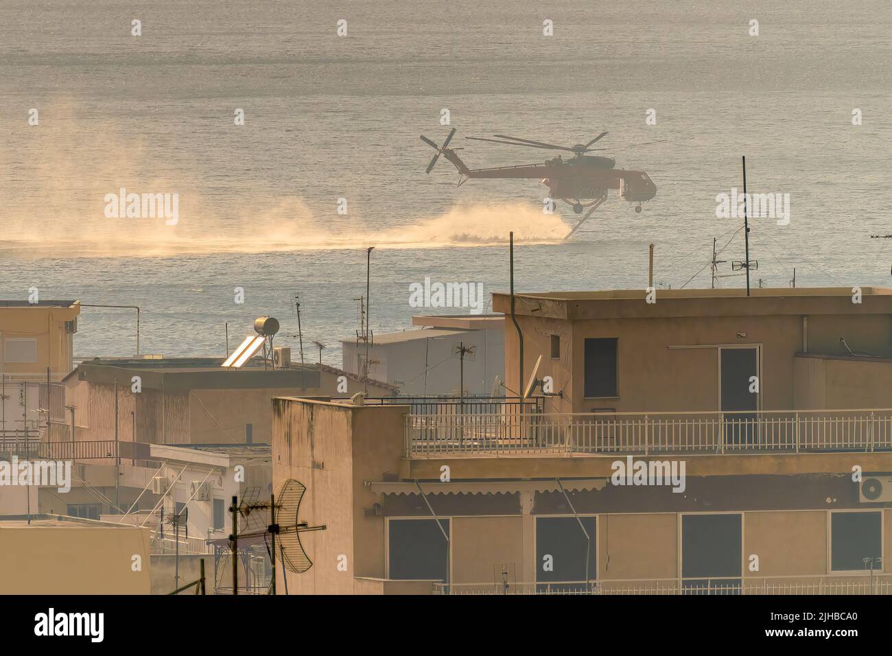 Loutraki, Greece 14 September 2019. Fire helicopter gathering water at Loutraki in Greece for the big fire. Stock Photo