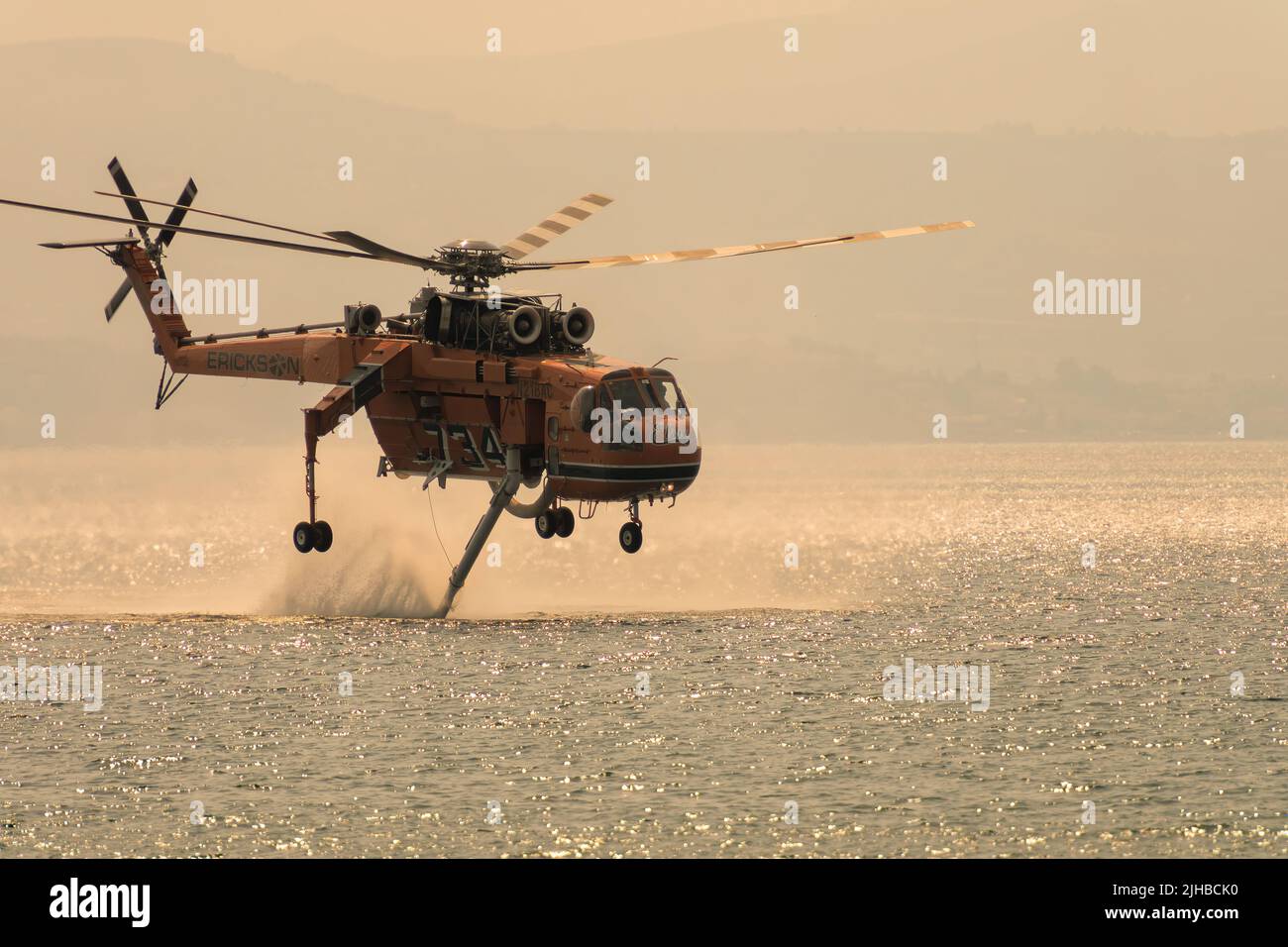 Loutraki, Greece 14 September 2019. Fire helicopter gathering water from the sea at Loutraki in Greece for the big fire. Close up view. Stock Photo