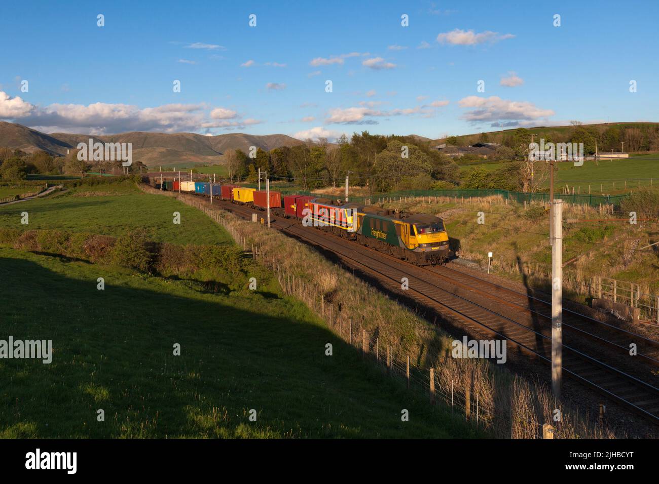 2 Freightliner class 90 electric locomotives passing the countryside at Grayrigg on the west coast mainline in Cumbria Stock Photo
