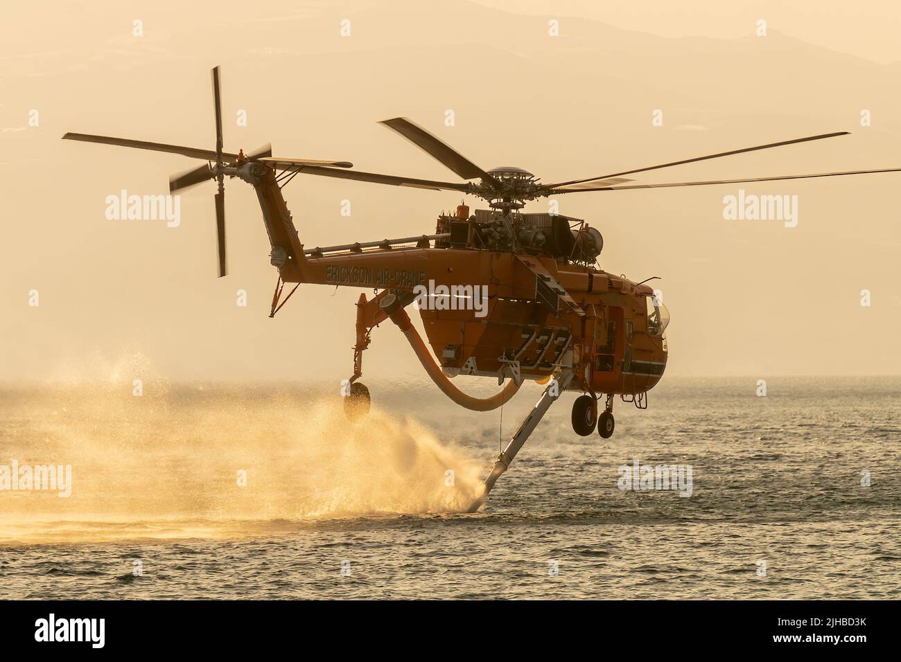 Loutraki, Greece 14 September 2019. Fire helicopter at Loutraki in Greece for the big fire gathering water against the sunset. Close up view. Stock Photo