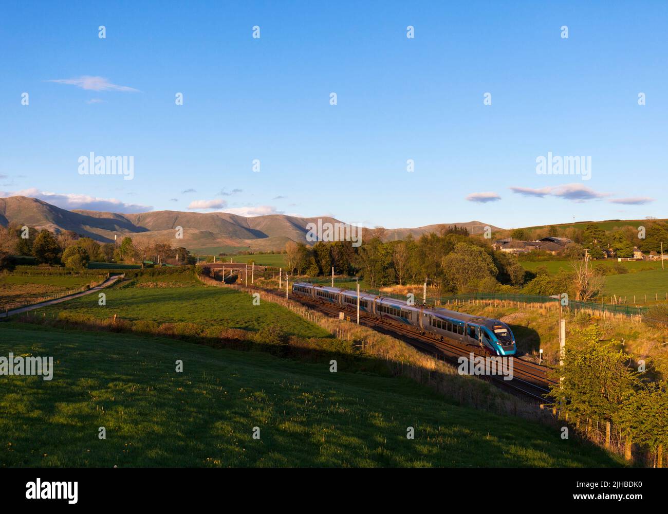 First Transpennine Express class 397 train passing  Grayrigg on the west coast mainline with the Howgill fells behind Stock Photo