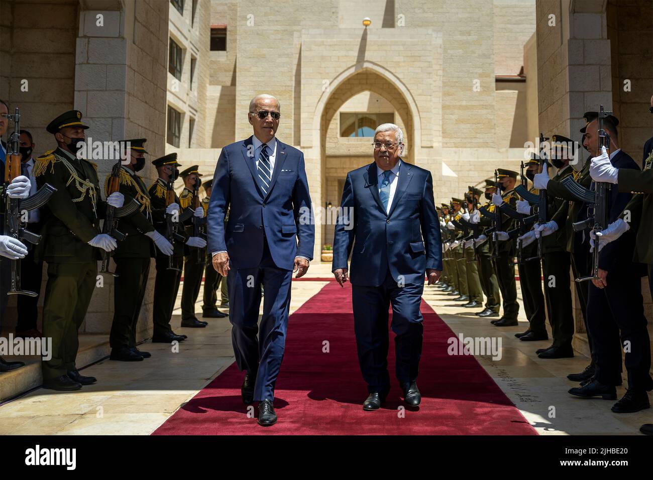 Bethlehem, Palestine. 15 July, 2022. U.S President Joe Biden, walks, is escorted past the honor guard by Palestinian President Mahmoud Abbas, right, at the Muqataa Presidential Compound, July 14, 2022 in Bethlehem, West Bank, Palestine. Credit: Adam Schultz/White House Photo/Alamy Live News Stock Photo