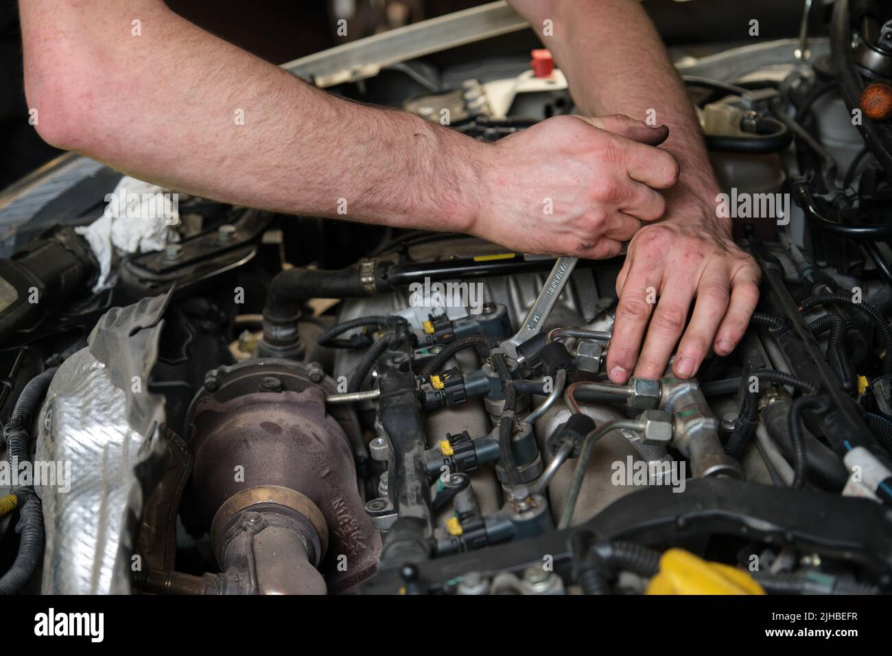 Technician removing fuel injectors checking dust and test pressure