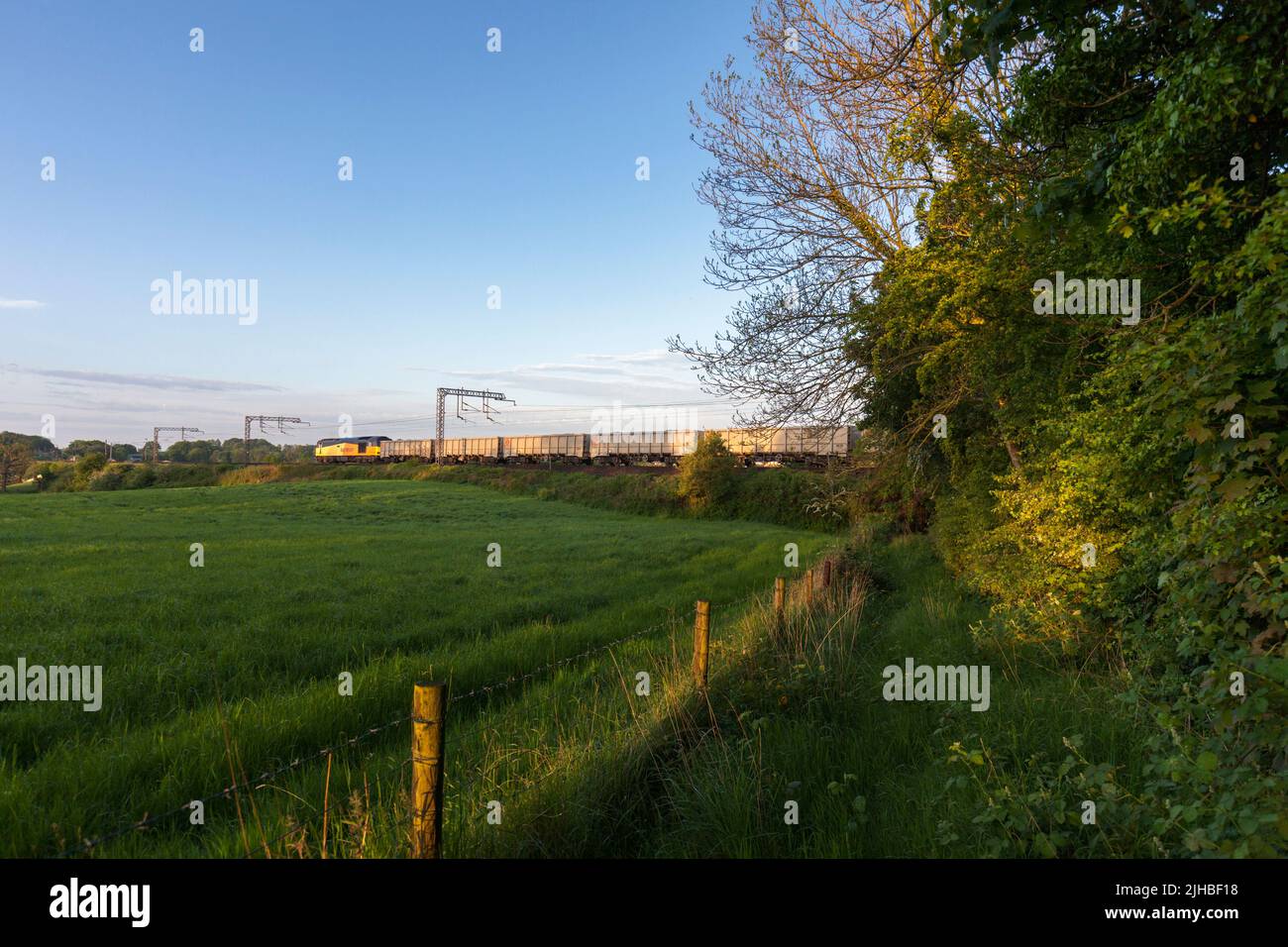 Freight train carrying aggregates in the countryside on the west coast mainline Stock Photo