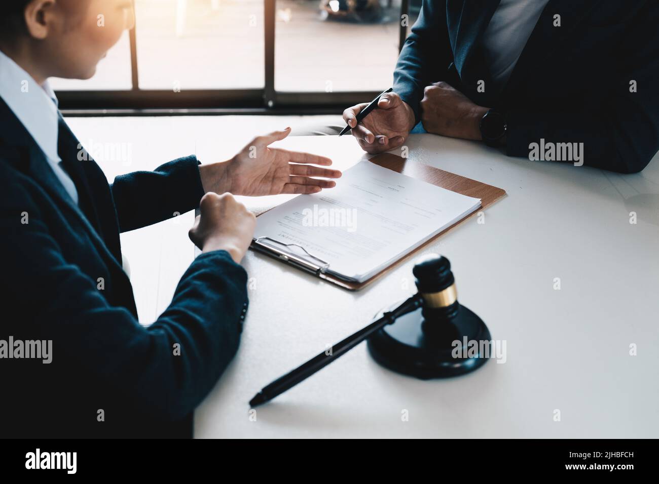 Lawyer and client with legal contract signing in law firm. Stock Photo