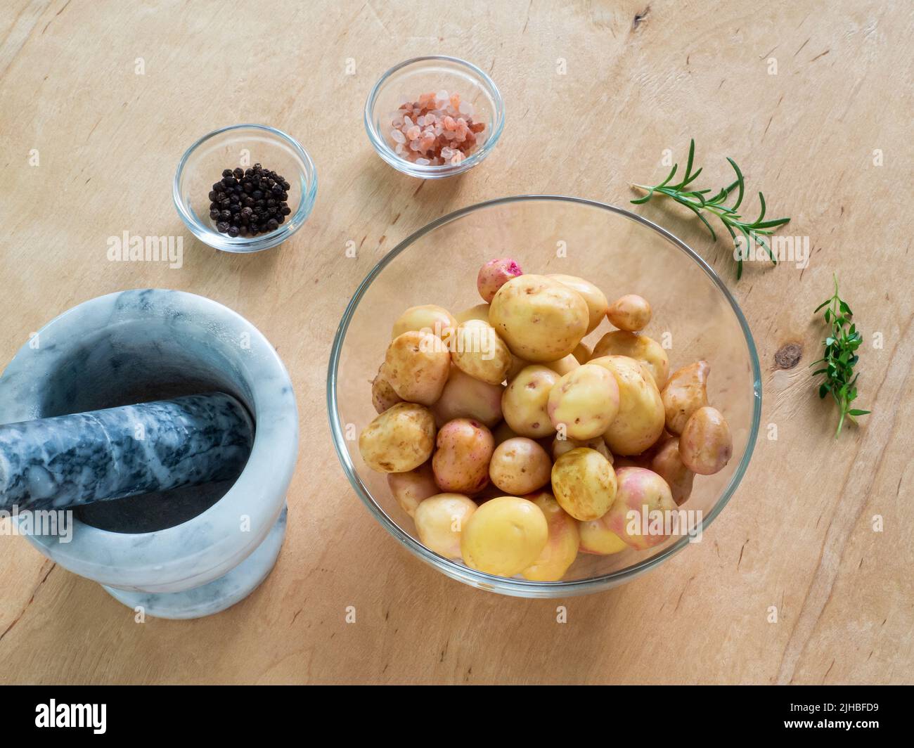 Wash and drain potatoes in bowl Stock Photo