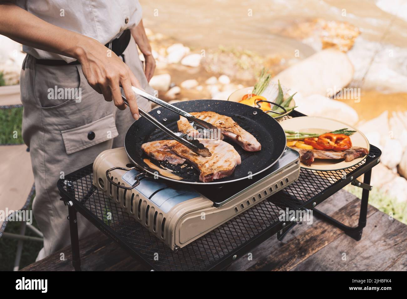 Close up grilling barbecue in the campground at summer camp travel