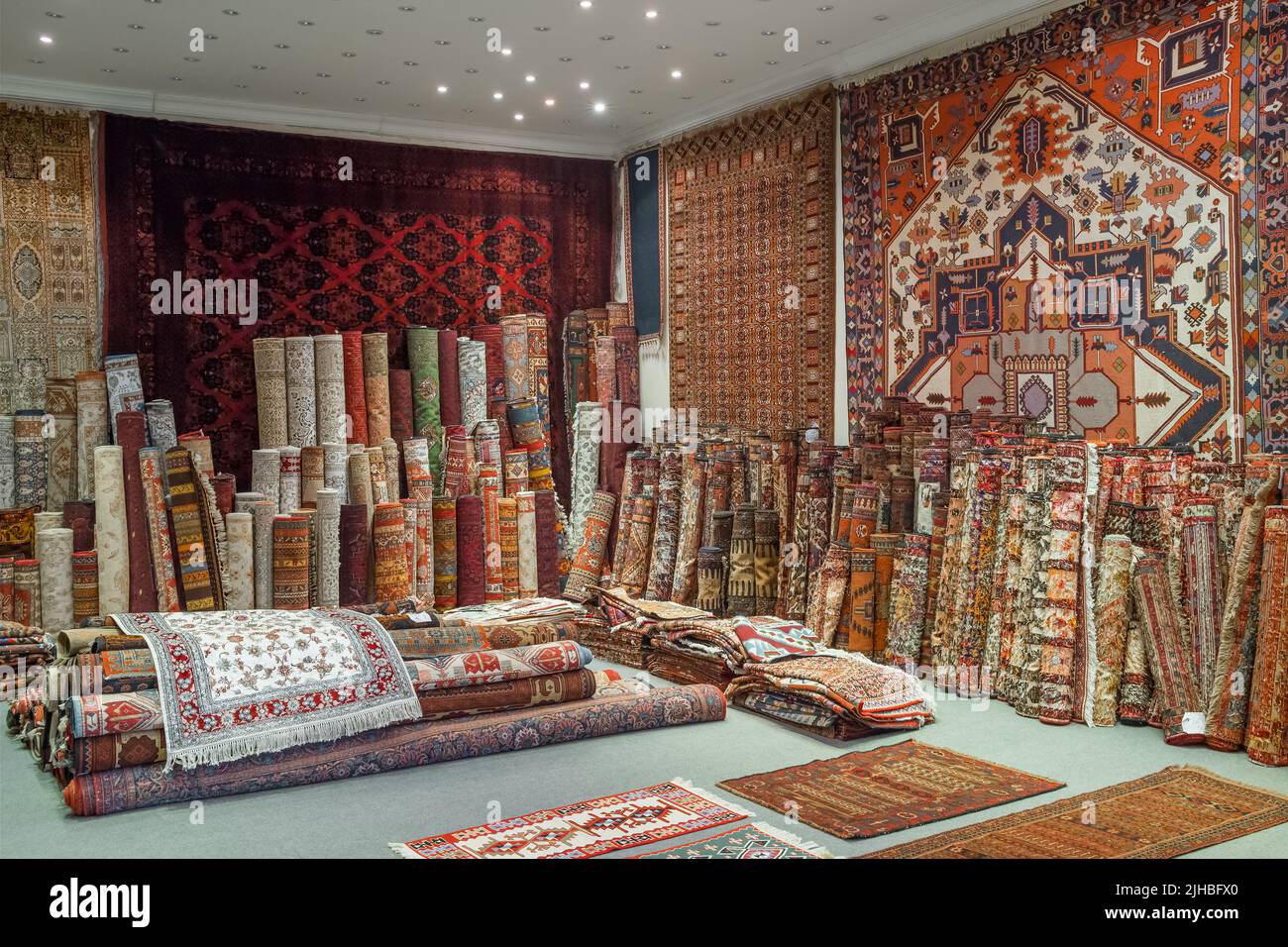 Variety of the gorgeous oriental carpets in traditional carpet store Stock Photo