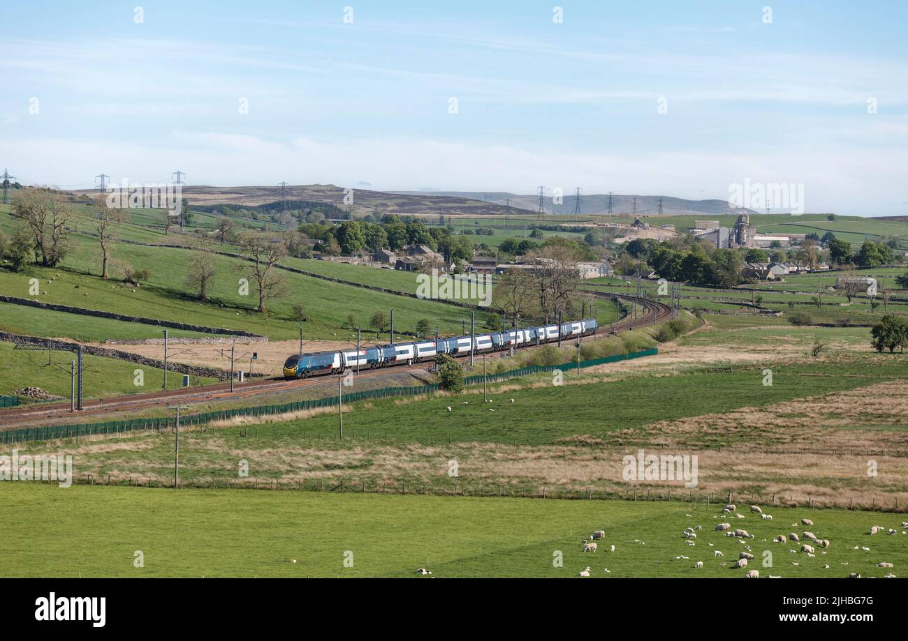 First Trenitalia Avant West Coast Alstom Pendolino train 390141 passing the countryside at Shap on the west coast mainline in Cumbria Stock Photo