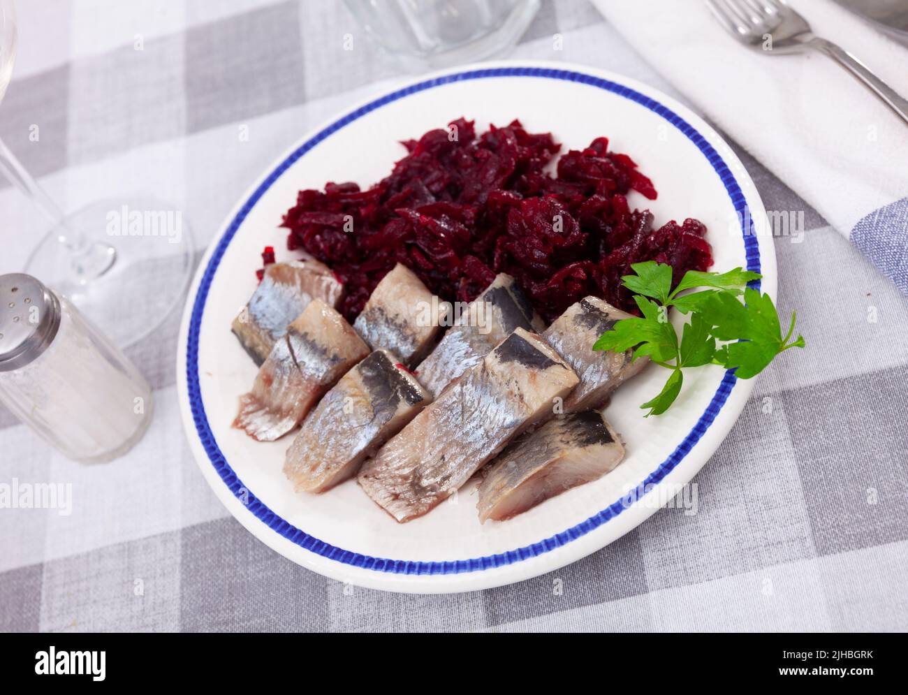 Sliced herring with grated beetroot served on table Stock Photo