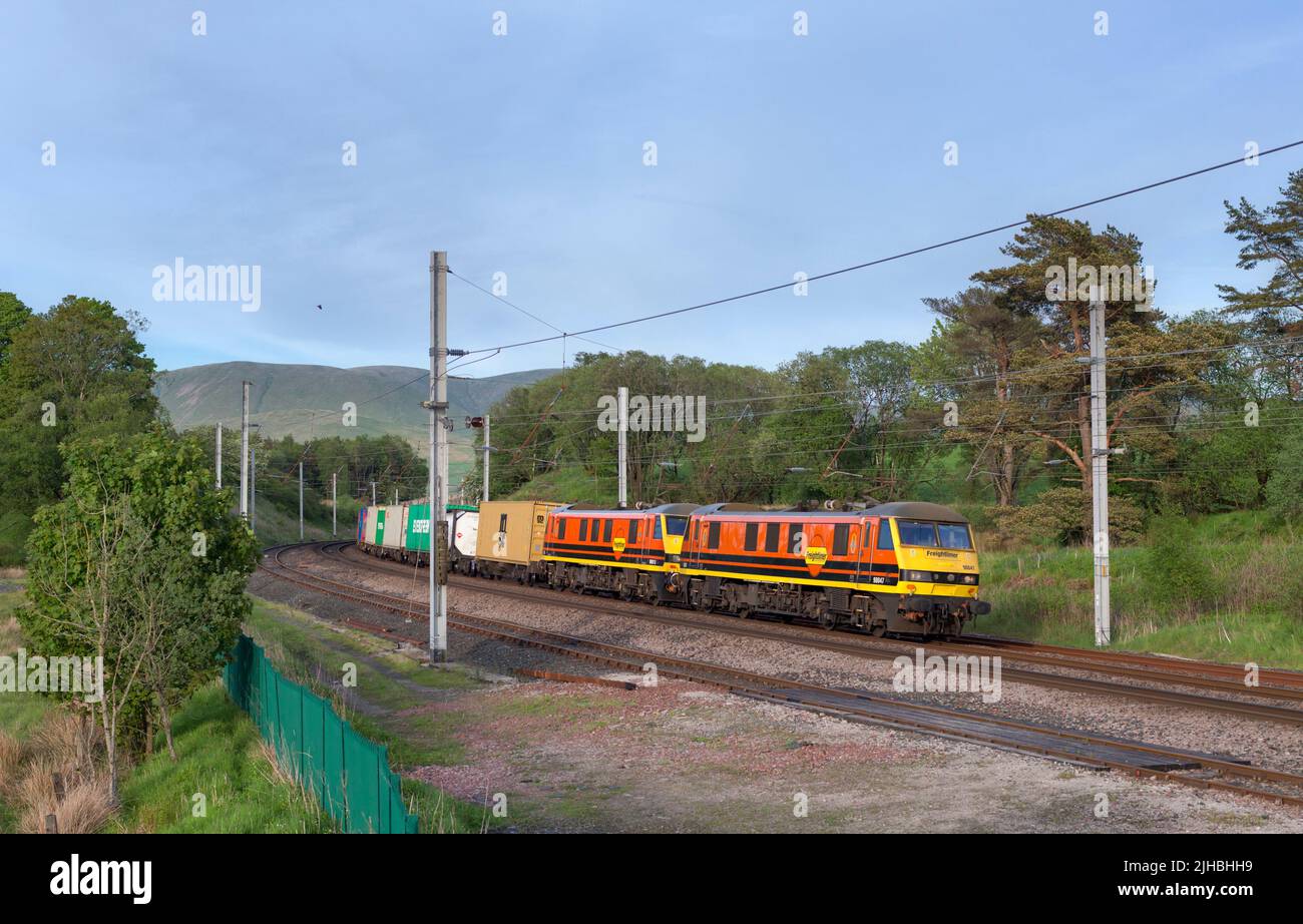 2 Freightliner class 90 electric locomotives passing Grayrigg loops on the west coast mainline in Cumbria Stock Photo