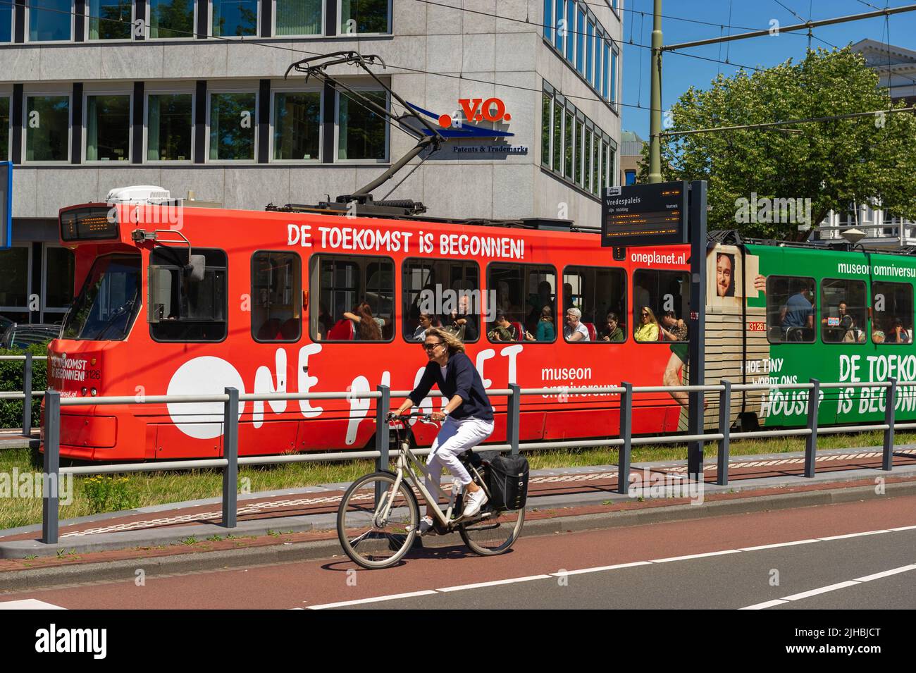 HTM Dutch Tram at Vredespaleis with a cyclist in the foreground, The Hague, The Netherlands Stock Photo