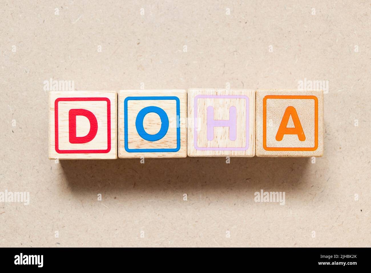Color letter block in word doha on wood background Stock Photo - Alamy