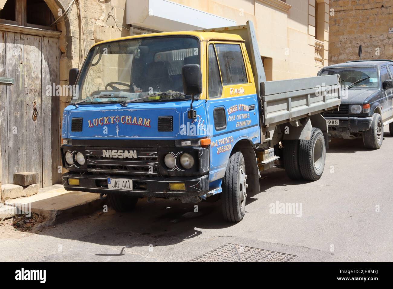 A 1990s Nissan Atlas flatbed decorated in traditional Maltese sign writing, Xaghra, Gozo, Malta. Stock Photo