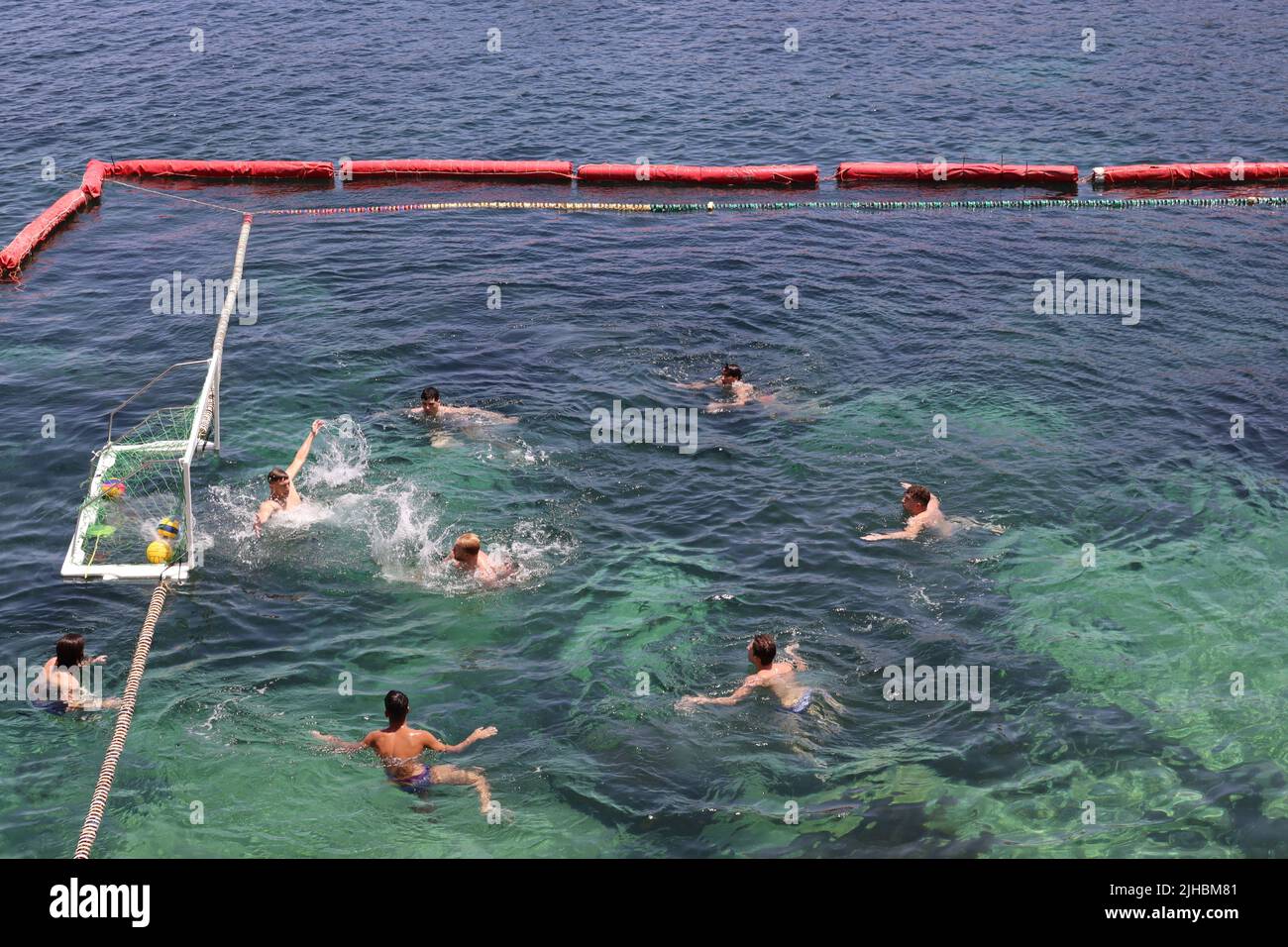 GOAL!! Water polo players during a training session in a sectioned off part of the bay at Marsalforn, Gozo, Malta Stock Photo