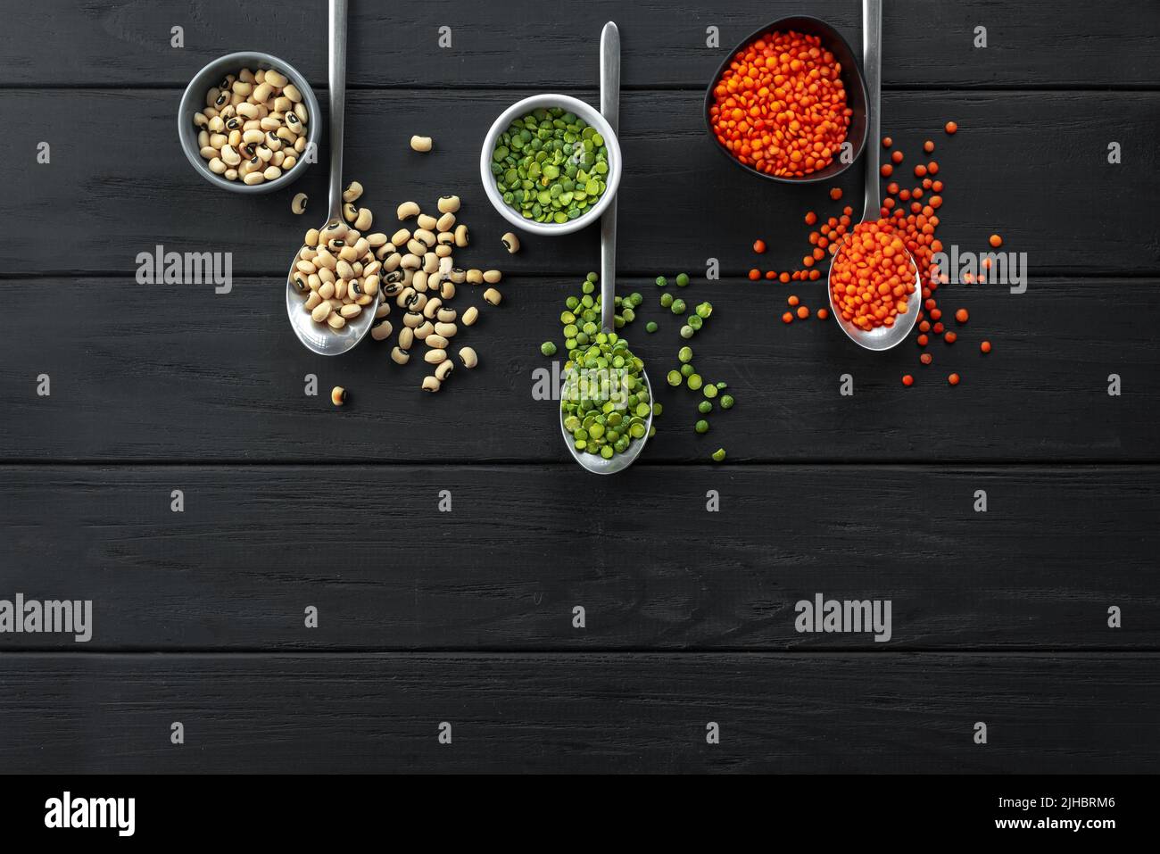 Superfood. Healthy, gluten-free meals. Lentils on spoon on a rustic dark wooden background. A set of useful Ancient grain foods on spoons on a dark Stock Photo