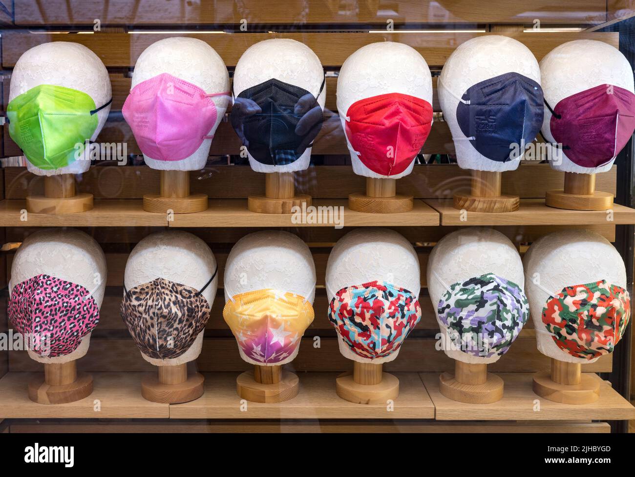 A display of fashionable and colourful facemaskes in a shop window in Rome, Italy. Stock Photo