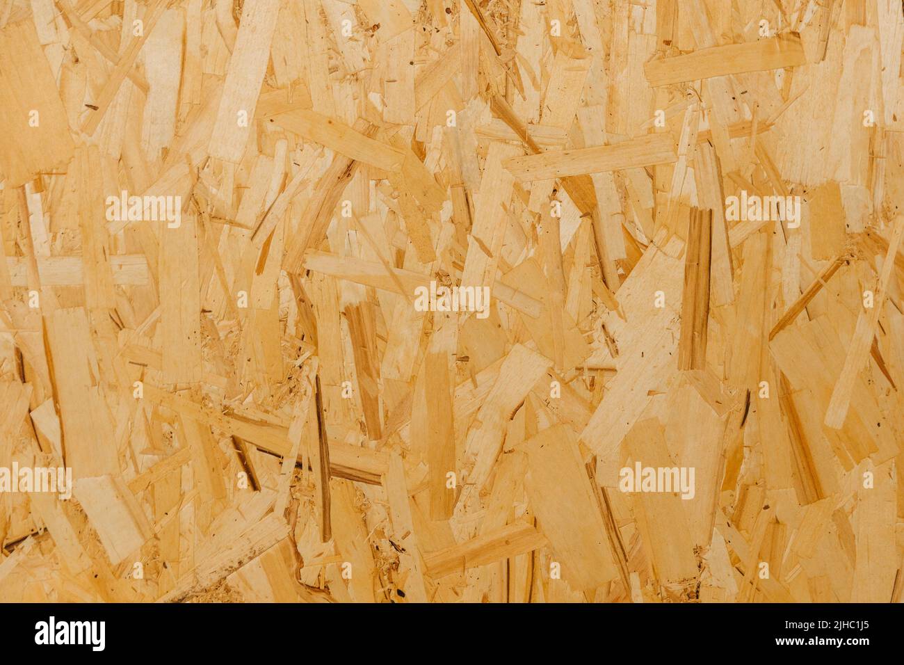 Close up pressed wooden panel background, texture of oriented strand board - OSB wood. Stock Photo